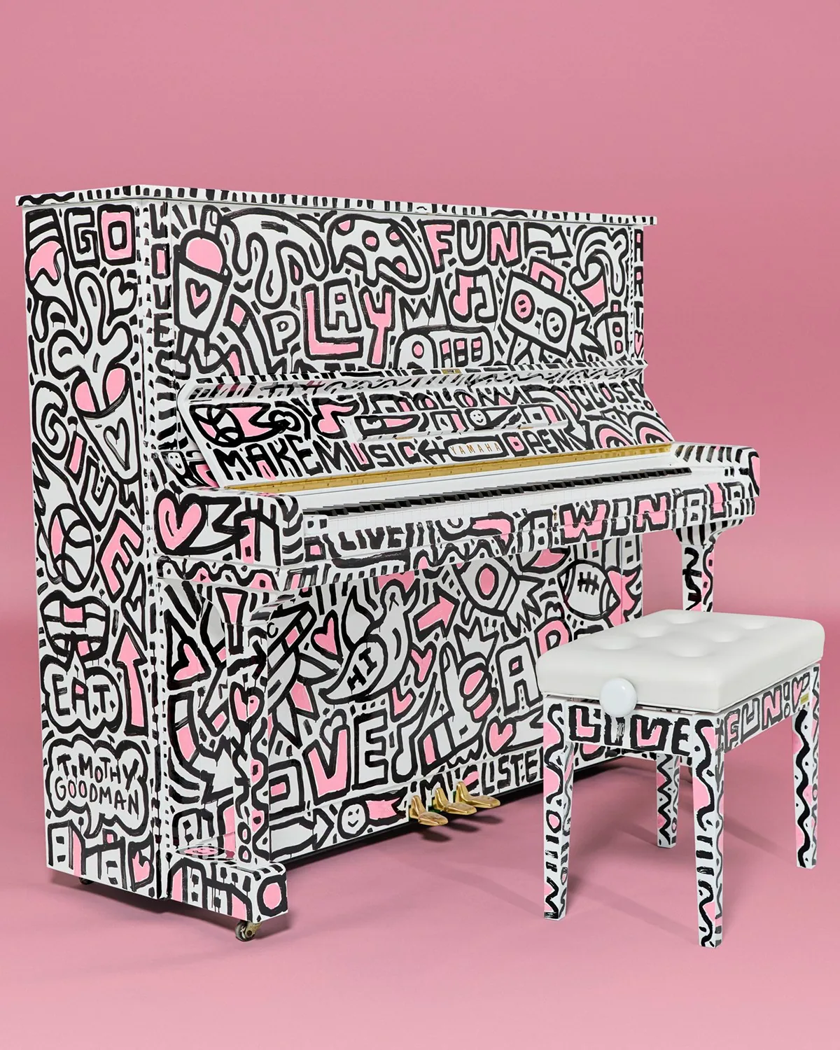 A hand-drawn piano on a pink set