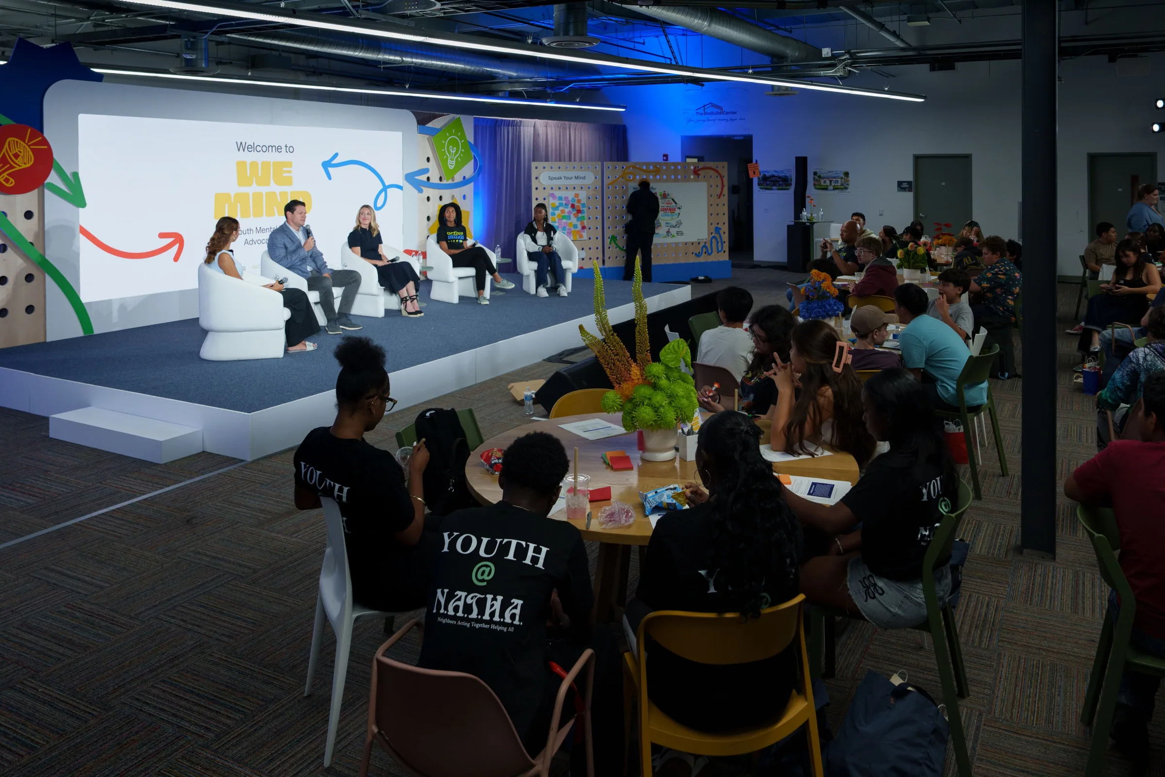 The panel with the audience at tables