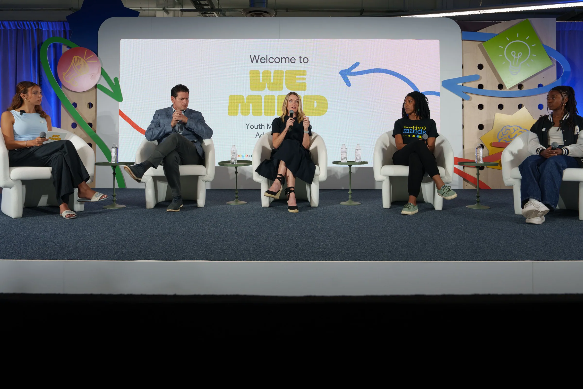 Five panelists on a stage with an illustrated Google and Active Minds backdrop