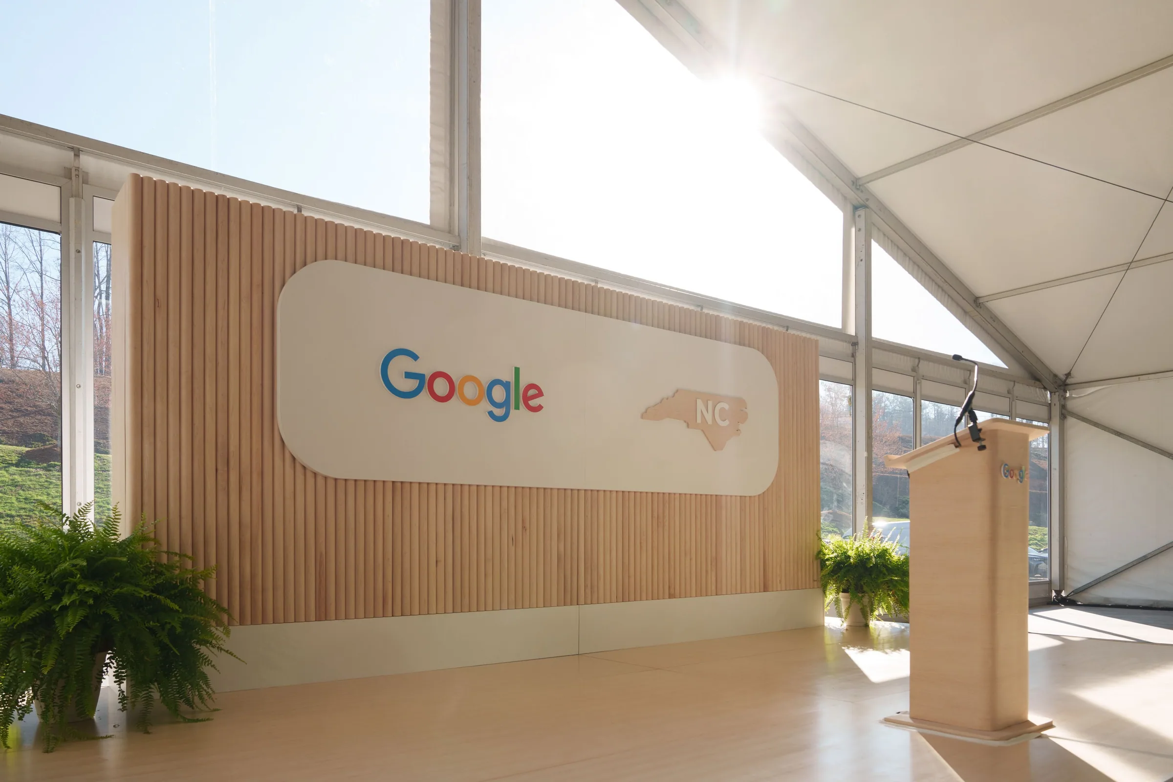 The empty stage with its wood slats and Google panel in morning light