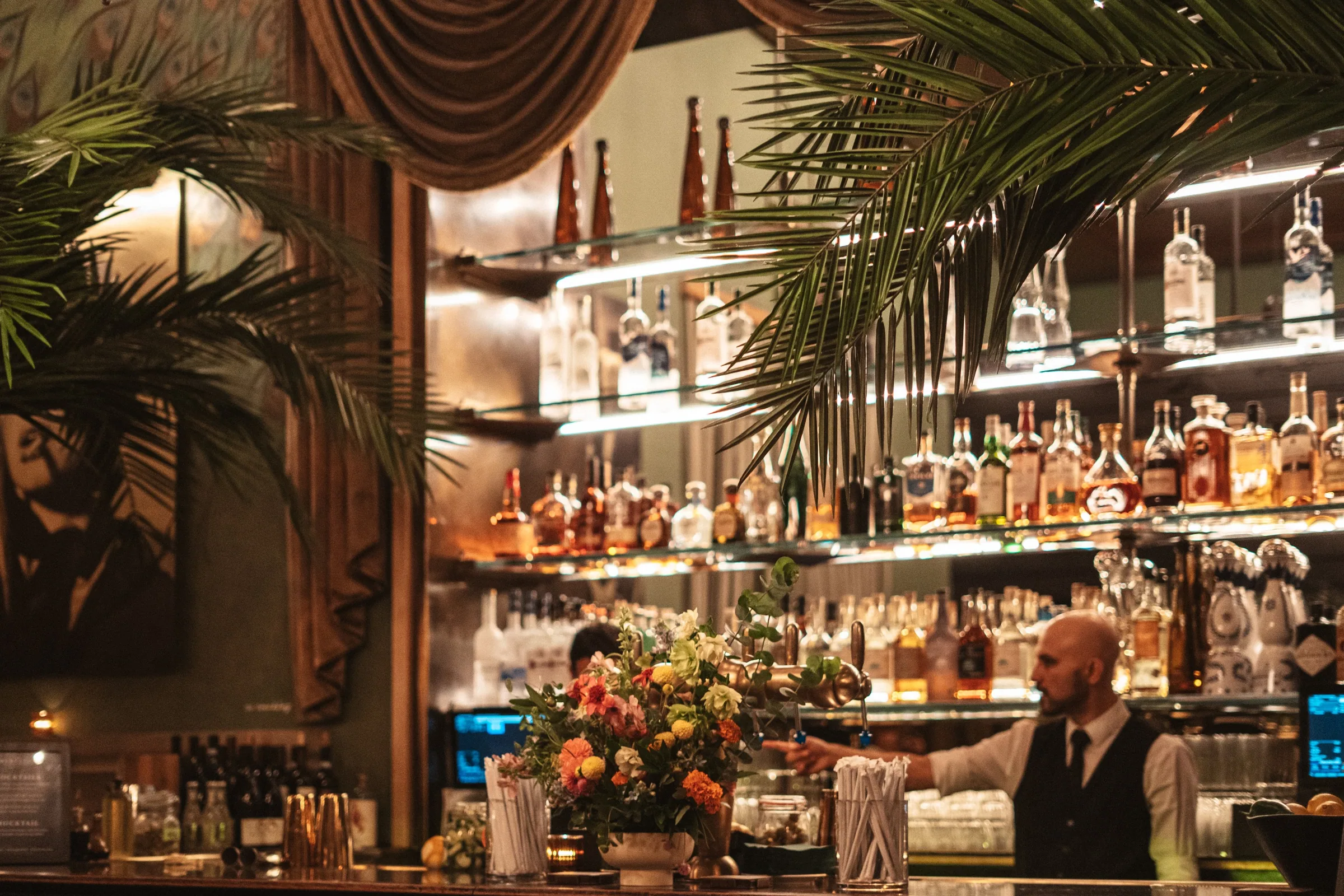 The after-party bar with flowers and palms