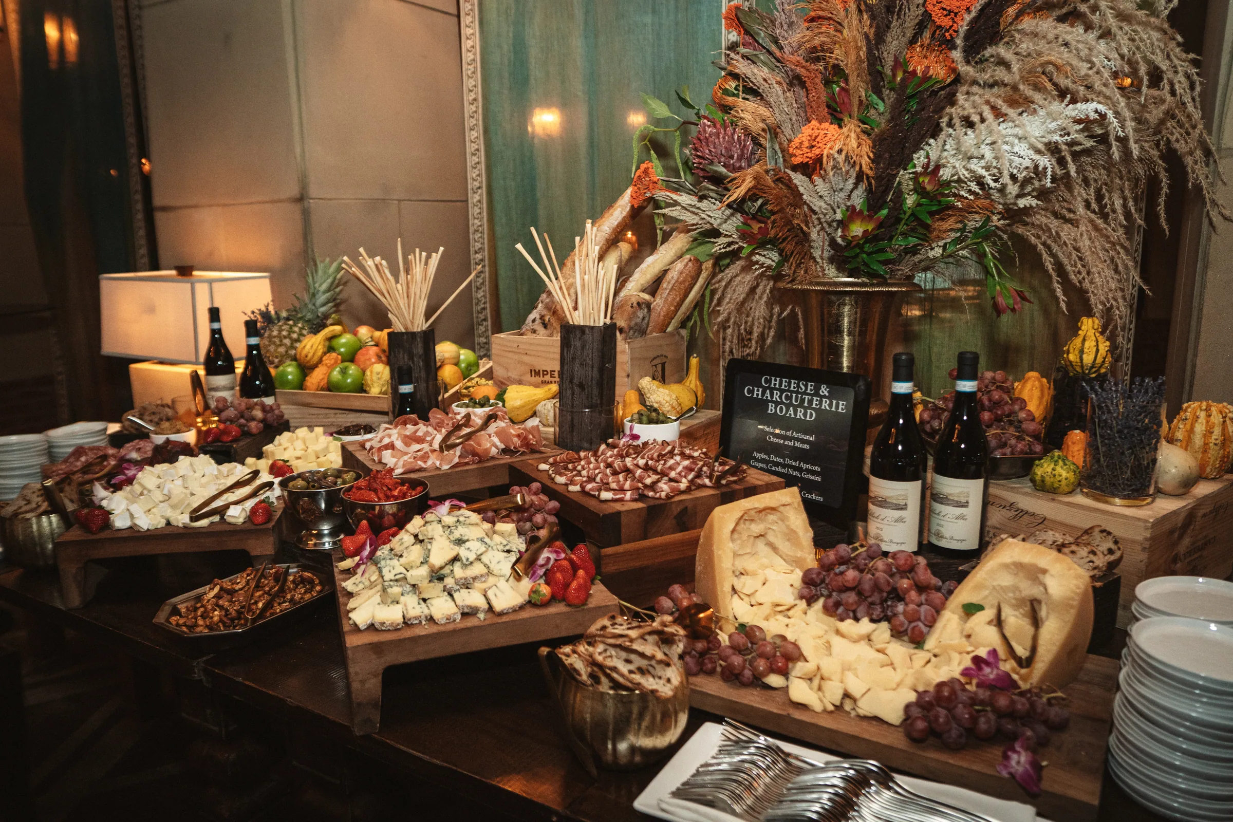 An after-party grazing table with autumn flowers and wine
