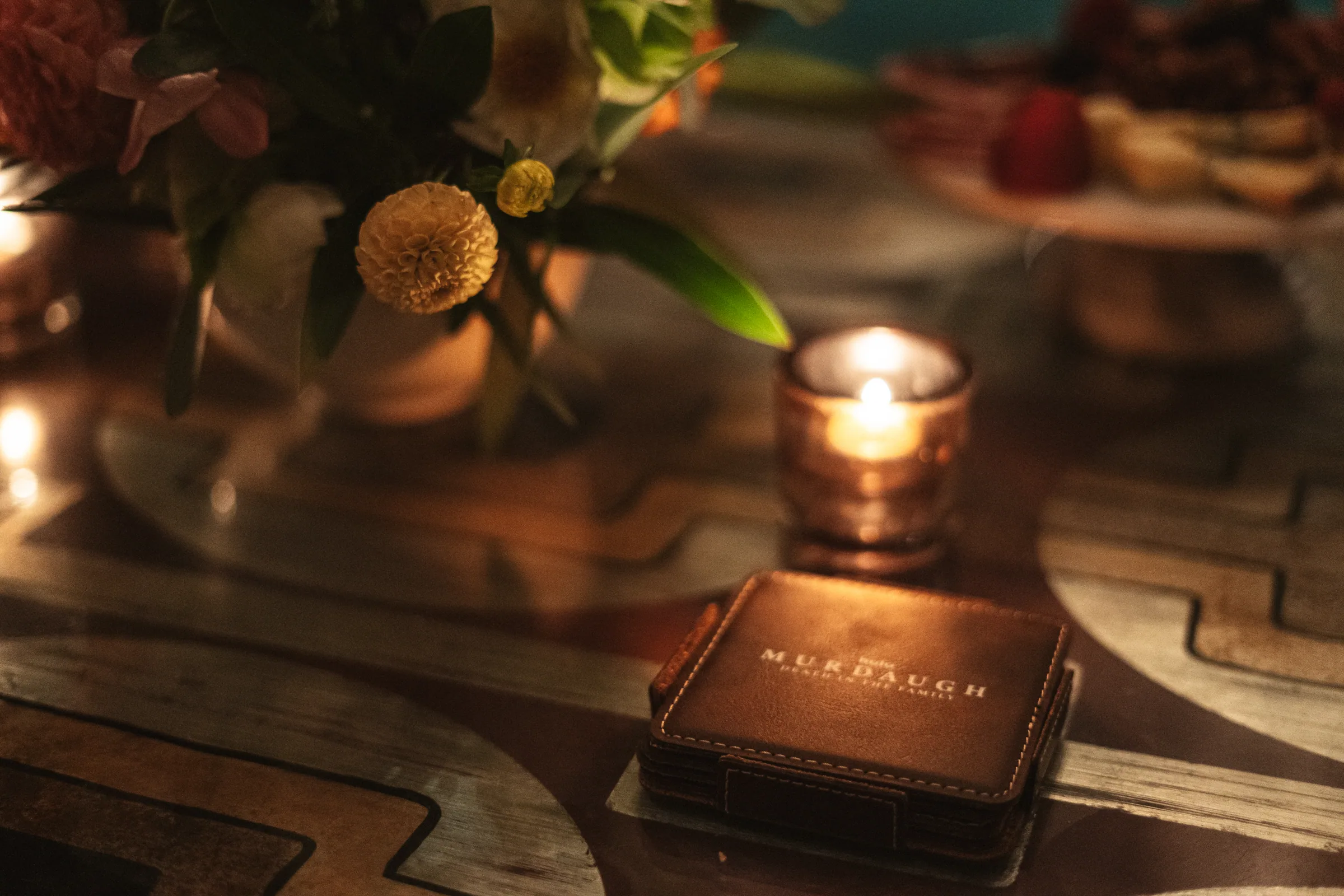 A leather Murdaugh coaster by candlelight