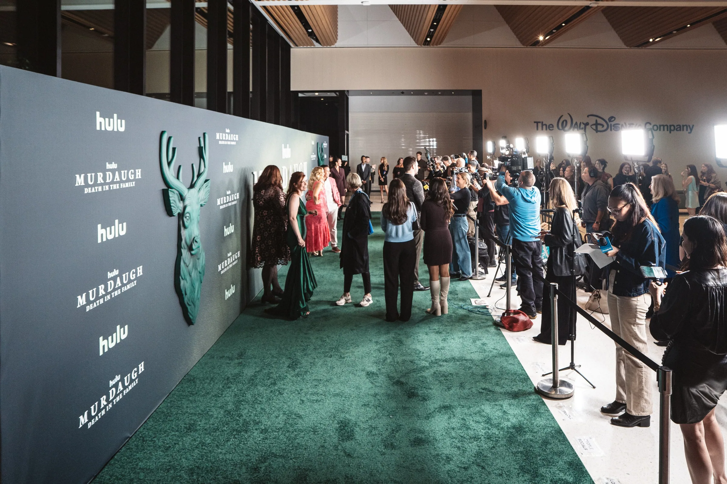 Guests and press along the green carpet