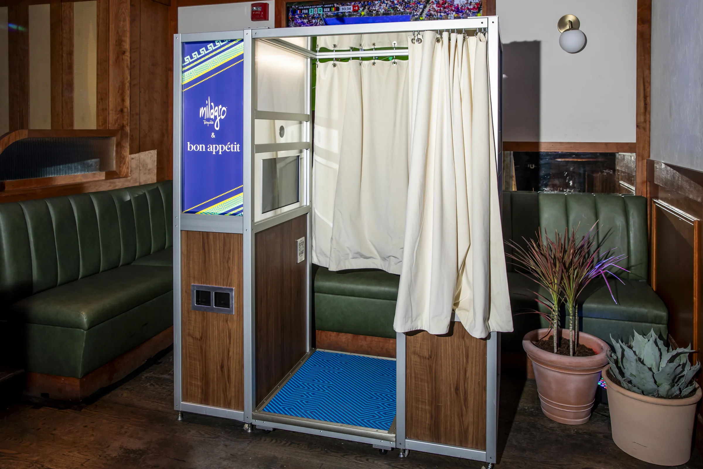 A photo booth wrapped in Milagro and Bon Appétit blue